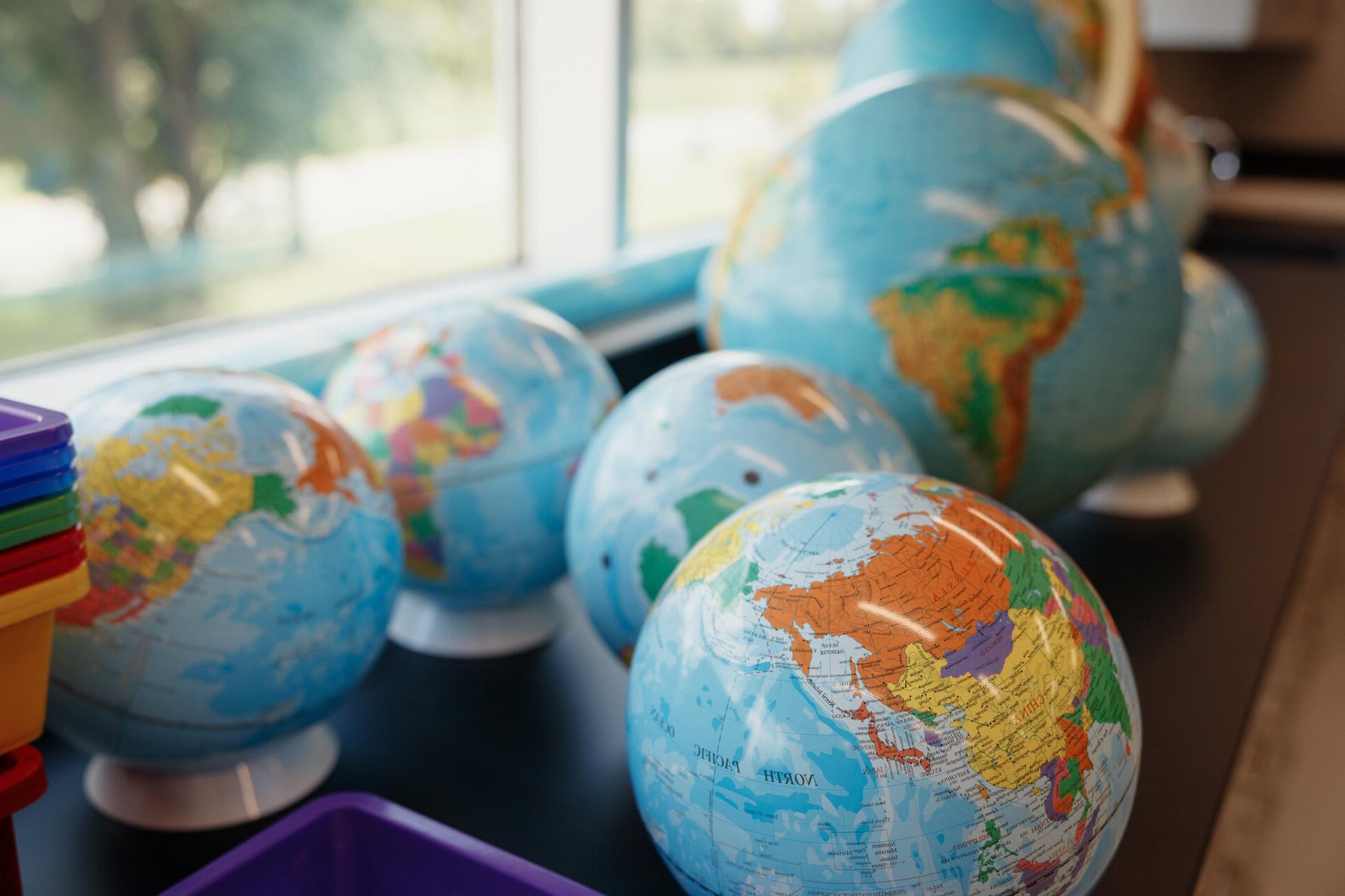 Classroom with globe and art on the walls.