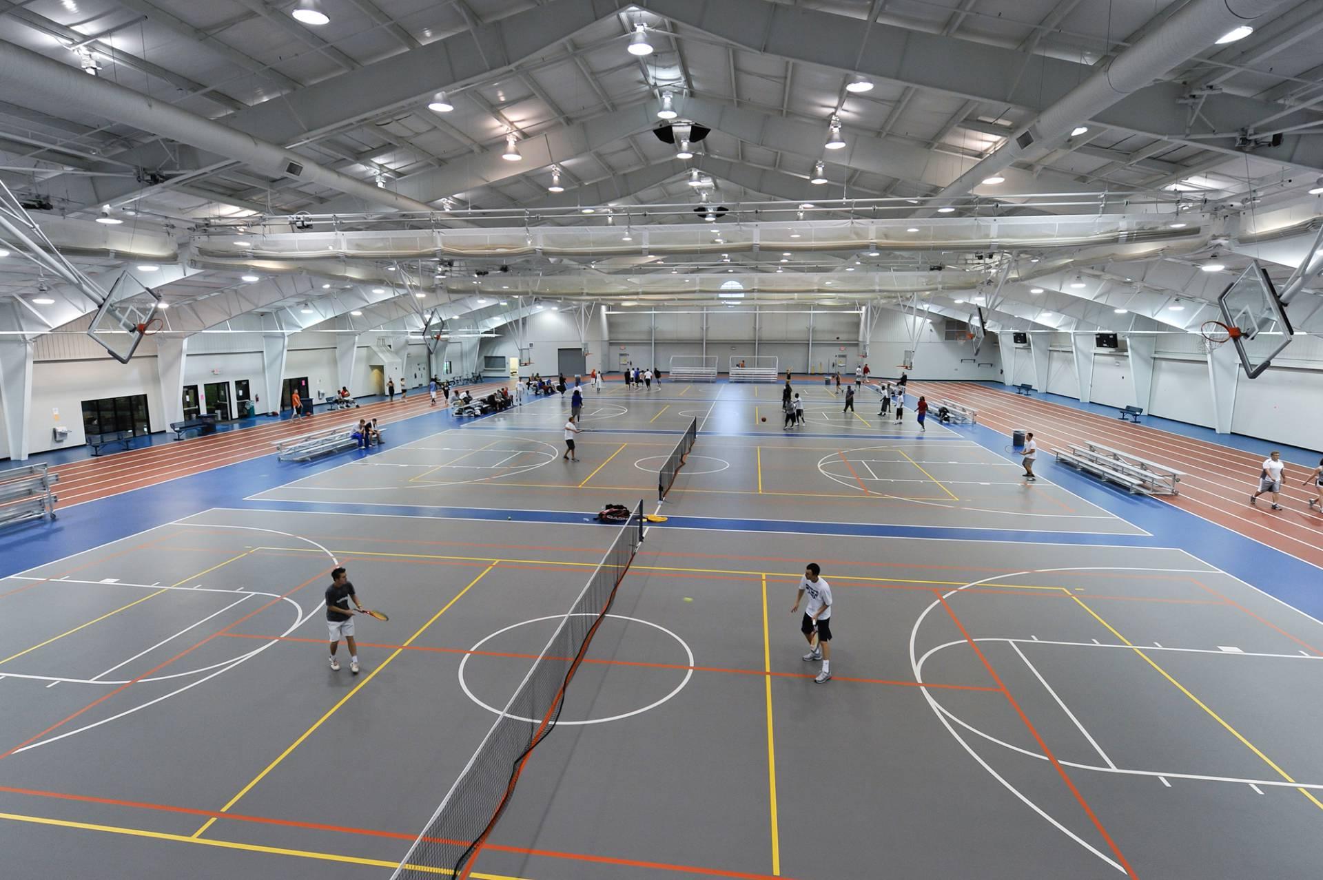 Students running around an indoor track.