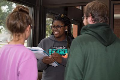 A social work major interviewing two other students